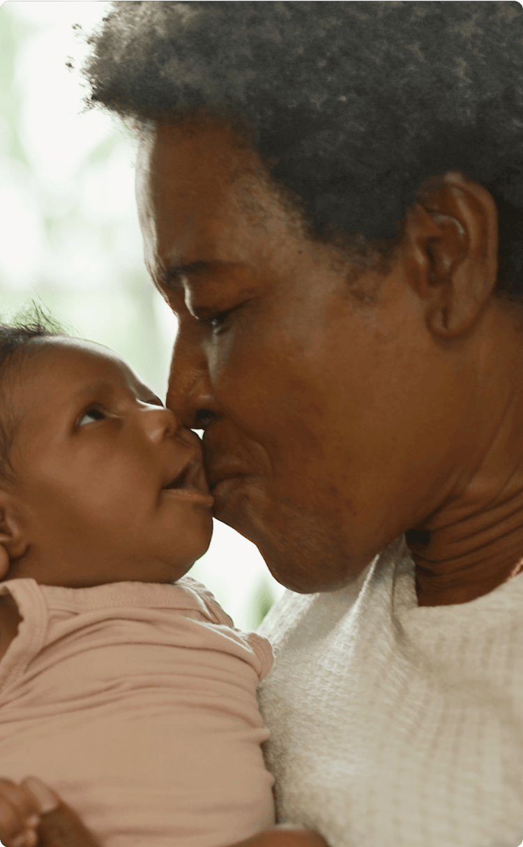 older adult and baby